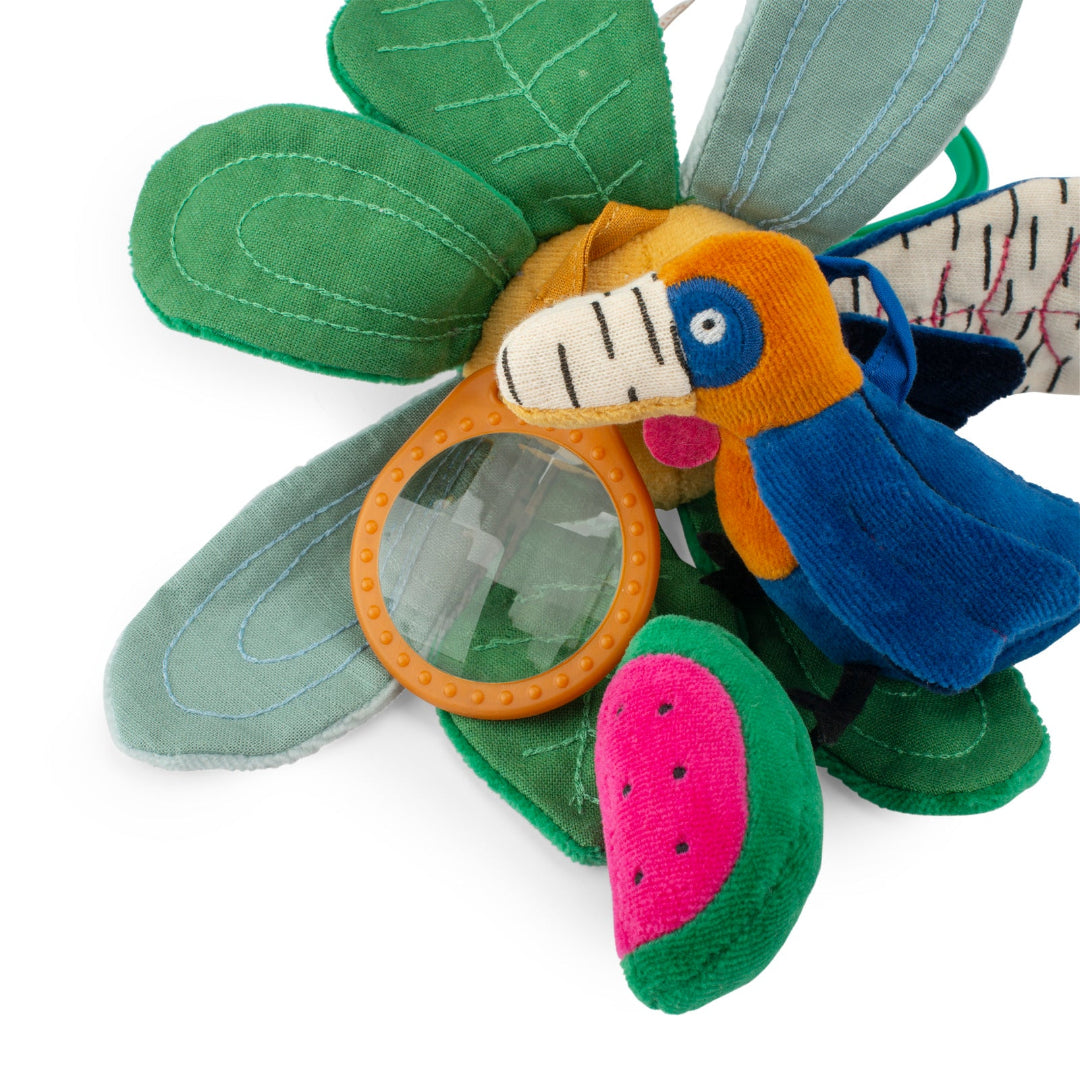Toy with a parrot design and green leaves on a white background