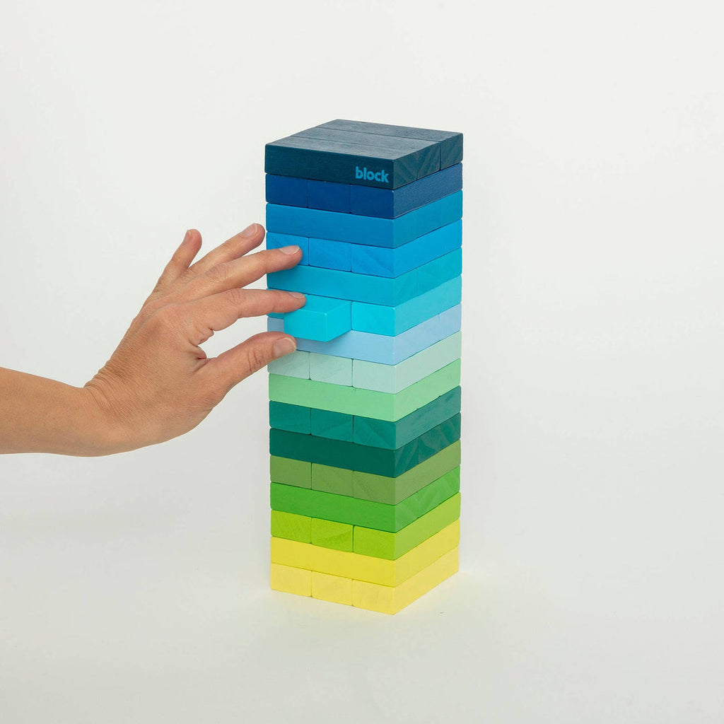 Block Design Warm Gradient Tower, a wooden tumbling tower game with painted blocks in a pink, coral and red gradient, image 9
