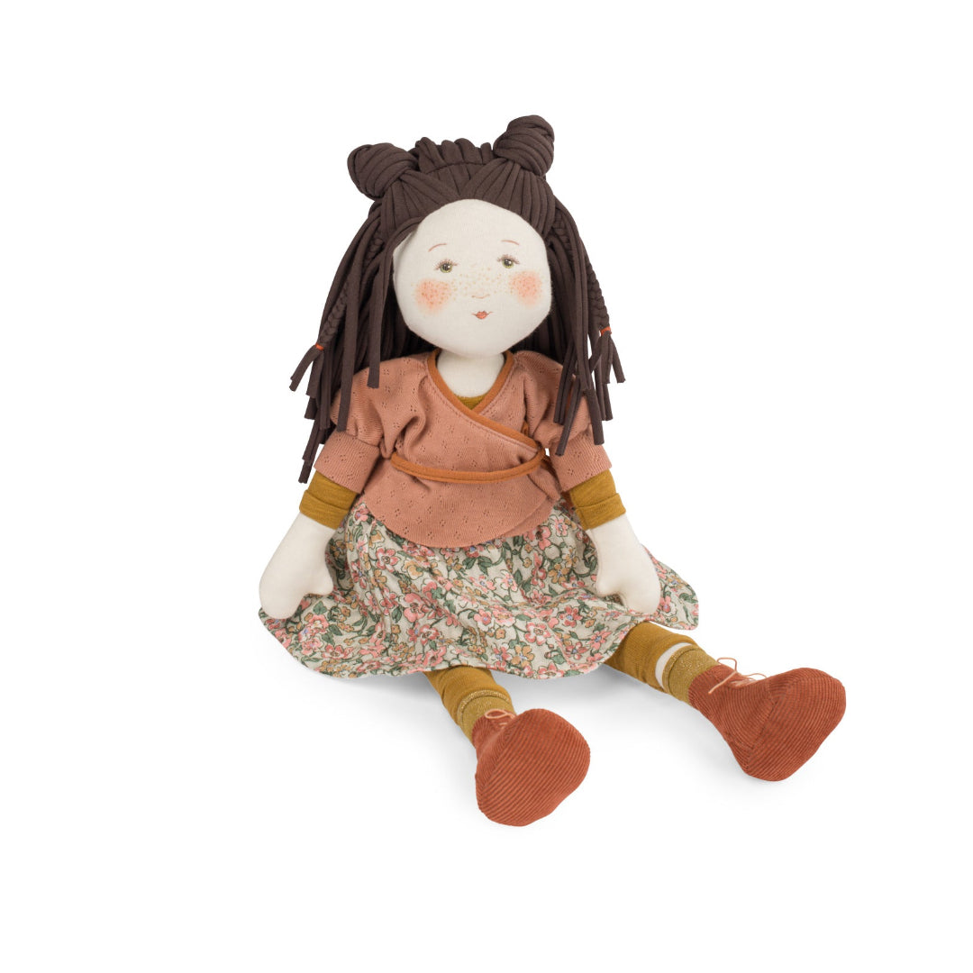 Stuffed doll with brown hair, floral dress, and brown shoes on a white background