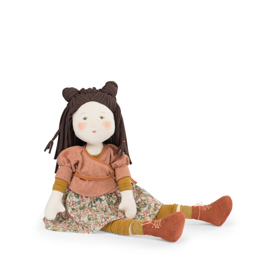 Stuffed doll with brown hair, wearing a floral dress and brown shoes on a white background