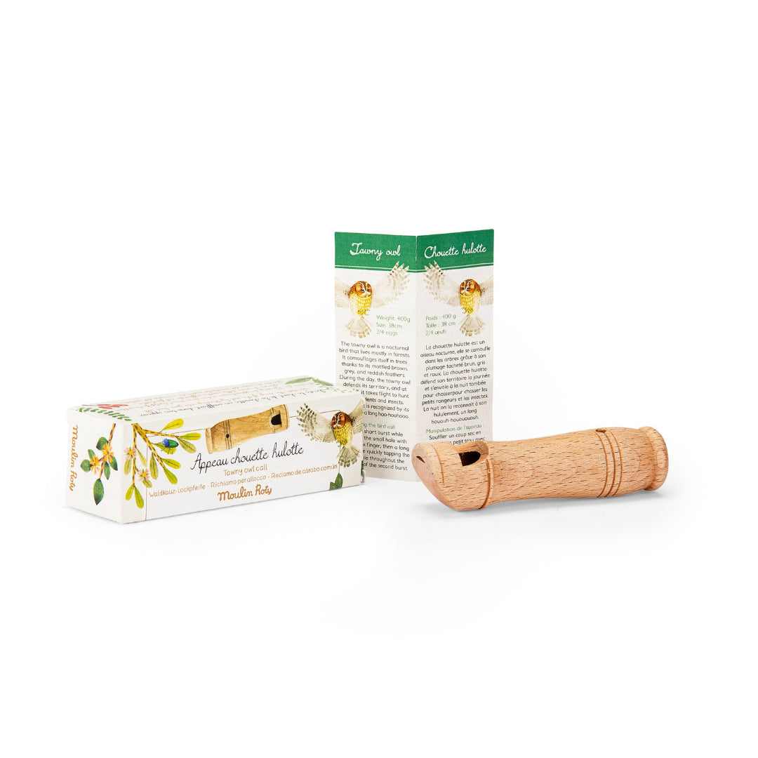 Wooden whistle with packaging on a white background