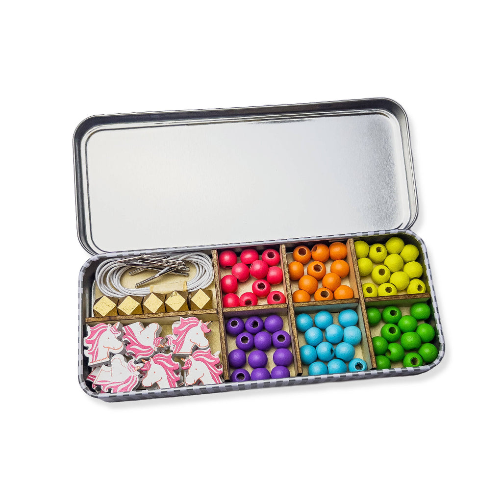 Colourful bead set in a tin box on a white background