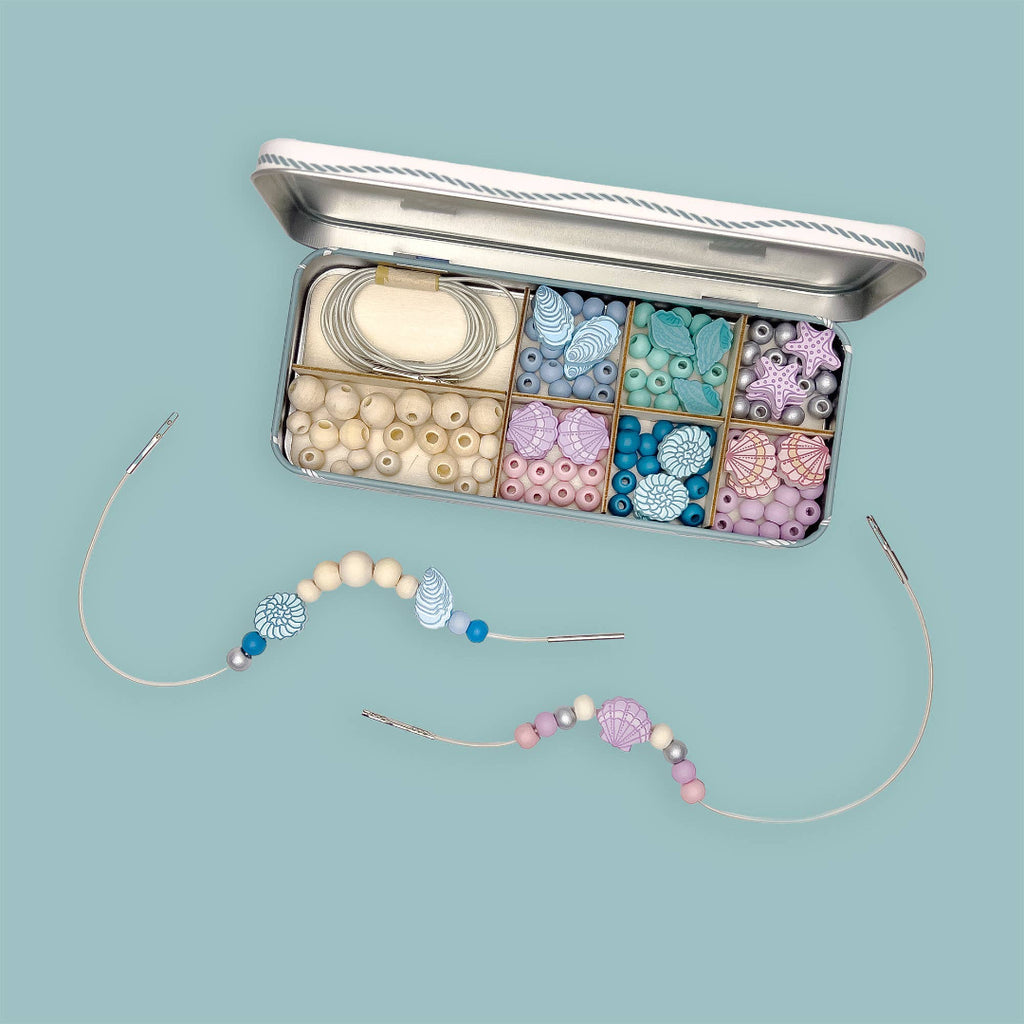 Bead kit with jewelry-making materials on a light blue background