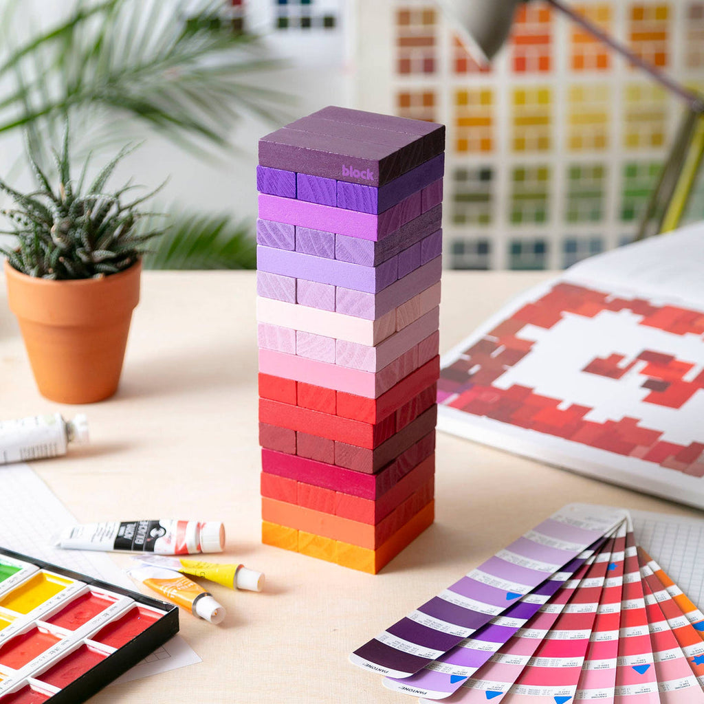 Block Design Warm Gradient Tower, a wooden tumbling tower game with painted blocks in a pink, coral and red gradient, image 7