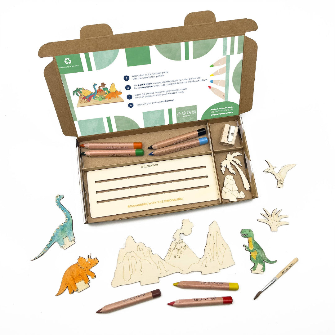 Wooden dinosaur modeling kit with tools and packaging on a white background