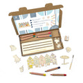 Coloring set with pencils, paper, and wooden beach-themed figures on a white background