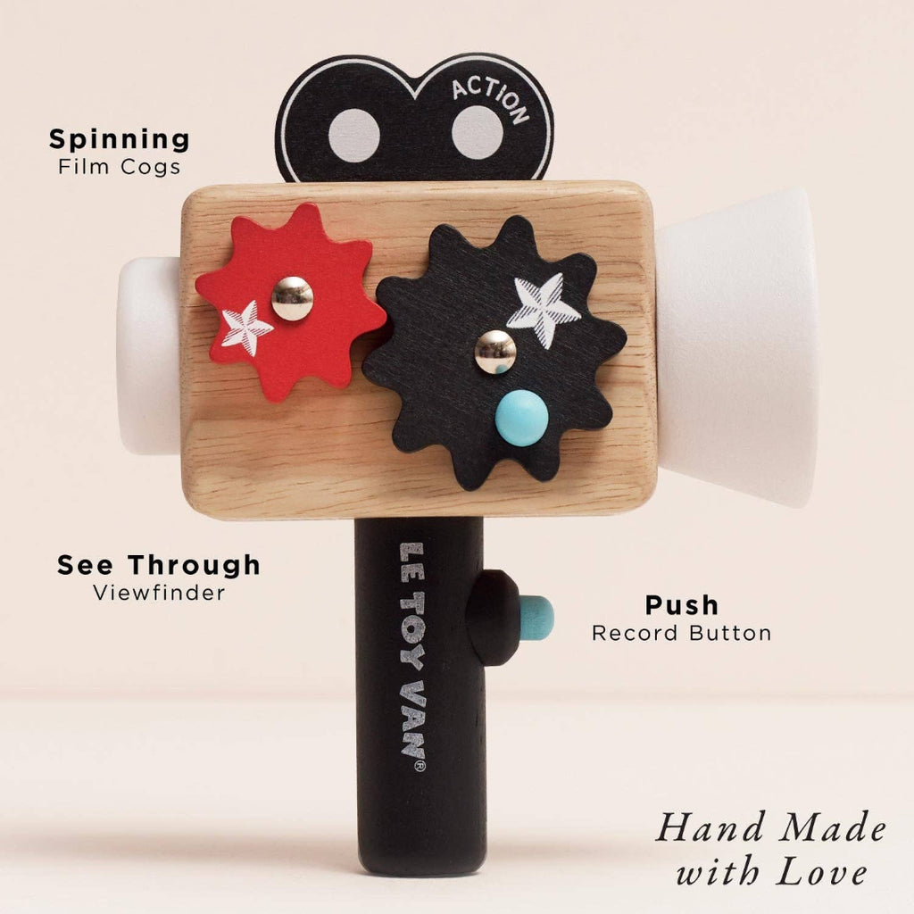 Wooden toy camera with labeled parts on a beige background