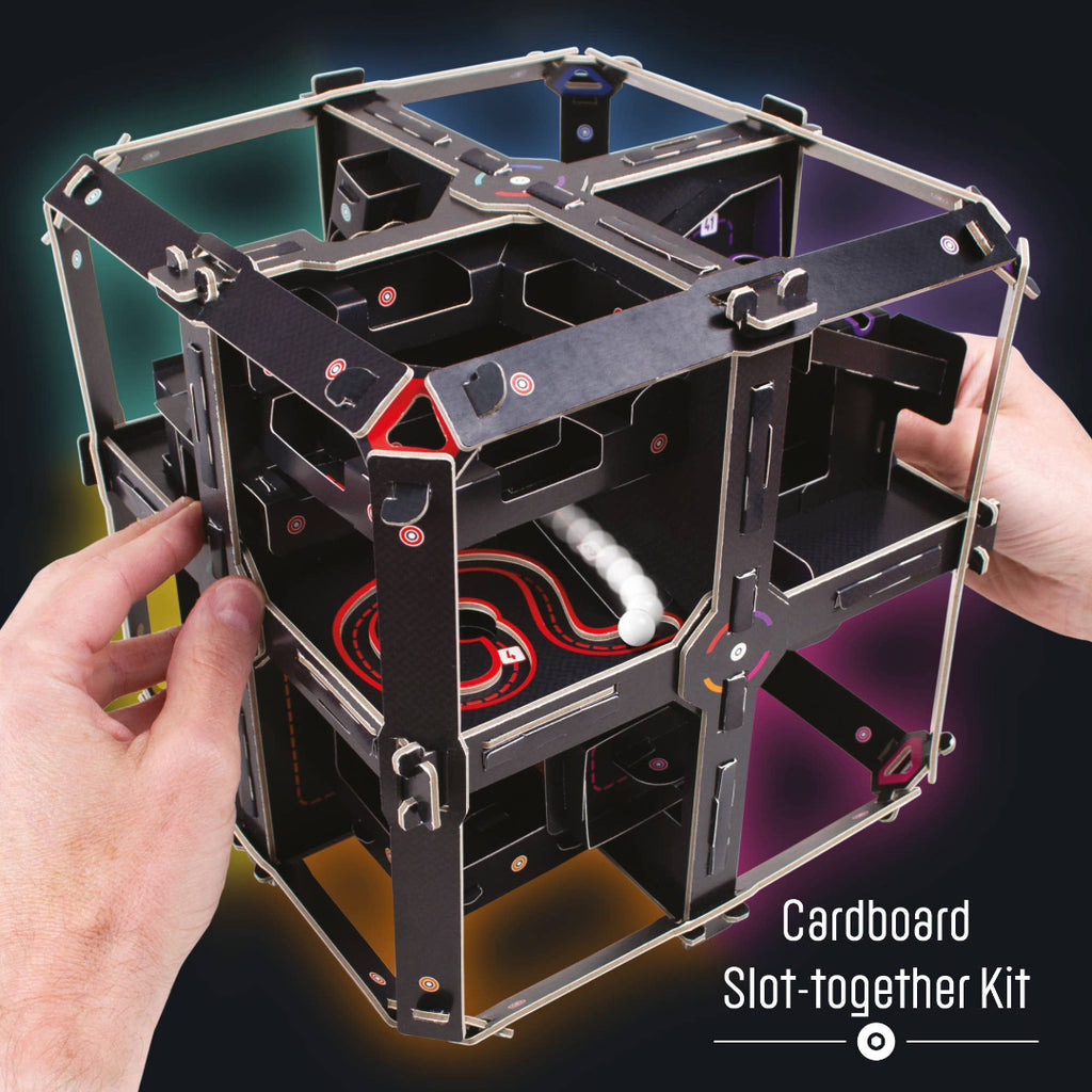 Cardboard slot-together kit held by hands with a dark gradient background