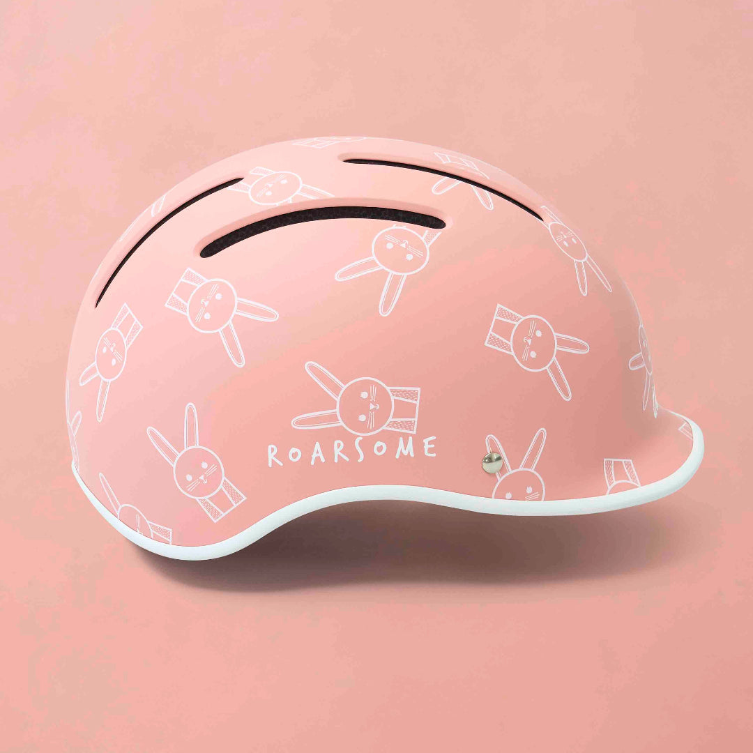 Pink helmet with white graphics on a pink background