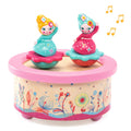 Toy music box with two animated fairy figures on a white background