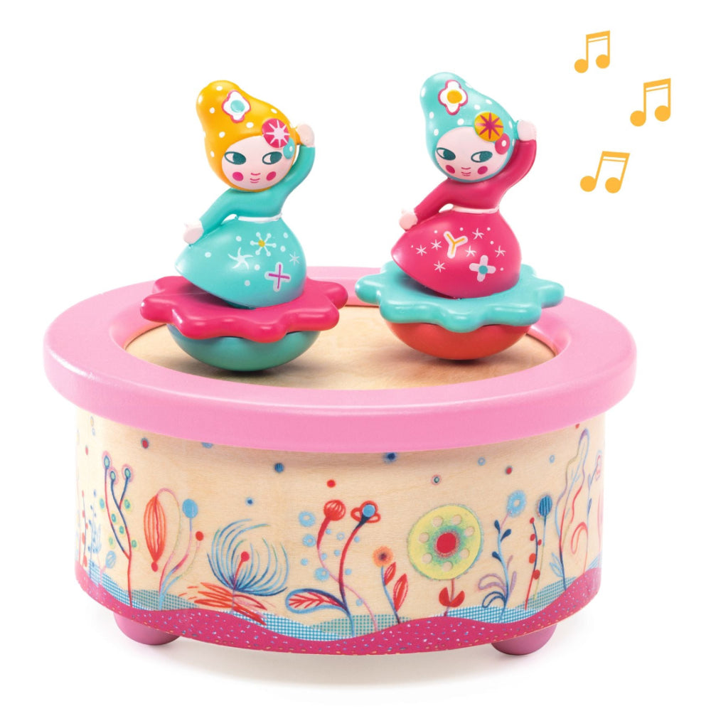Toy music box with two animated fairy figures on a white background