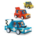 Three finished Djeco DIY Grand Prix racing cars: blue number 1, red number 2 and yellow, made from card with animal drivers