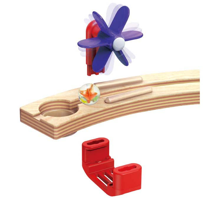 Woman and young girl playing with a colourful wooden toy in a bright living room.