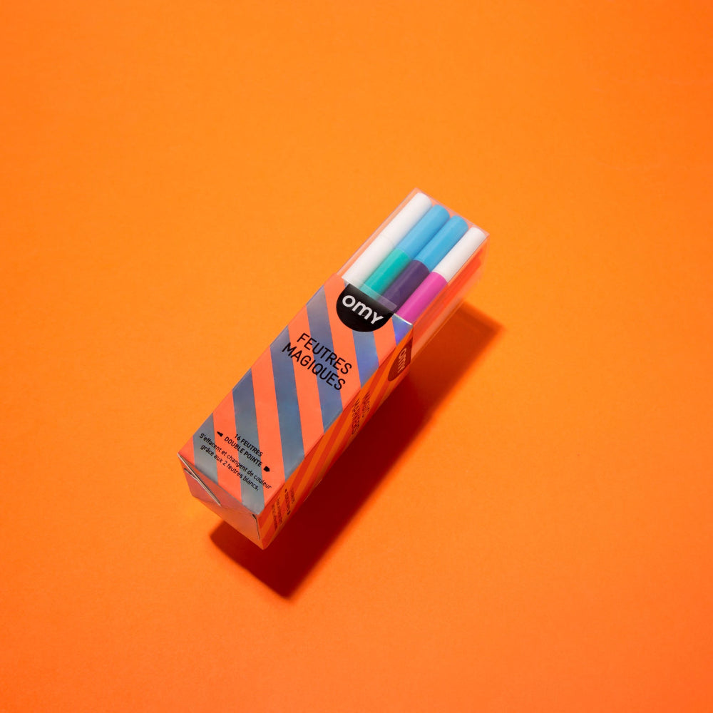 Box of colorful markers with 'omy' branding on an orange background