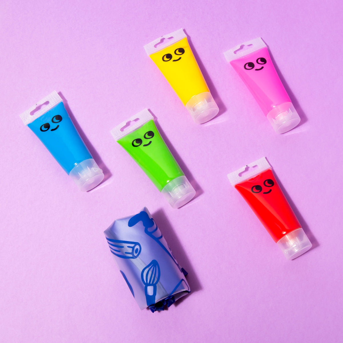 5 tubes of paint and folded smock.