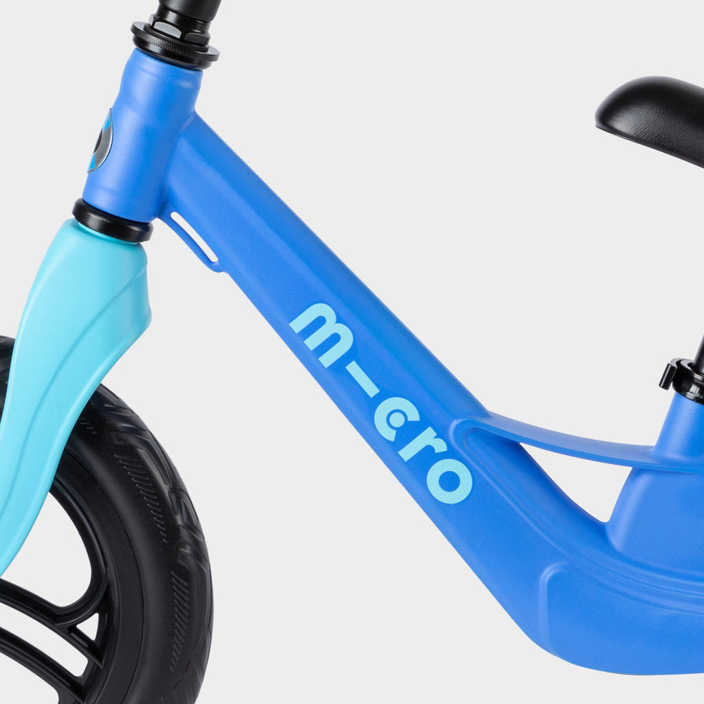 Close-up of the blue Micro Balance Bike Lite frame with the light blue micro logo