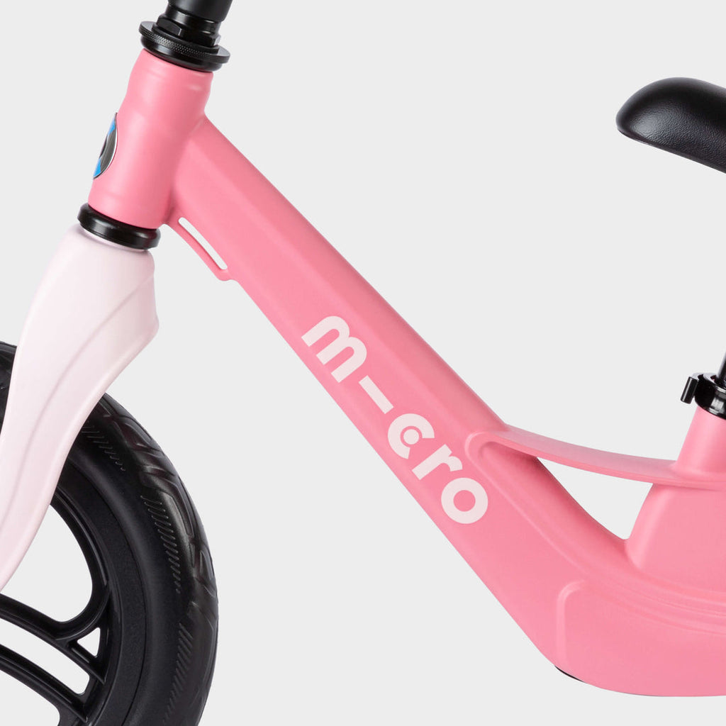 Close-up of the pink Micro Balance Bike Lite frame with the white micro logo