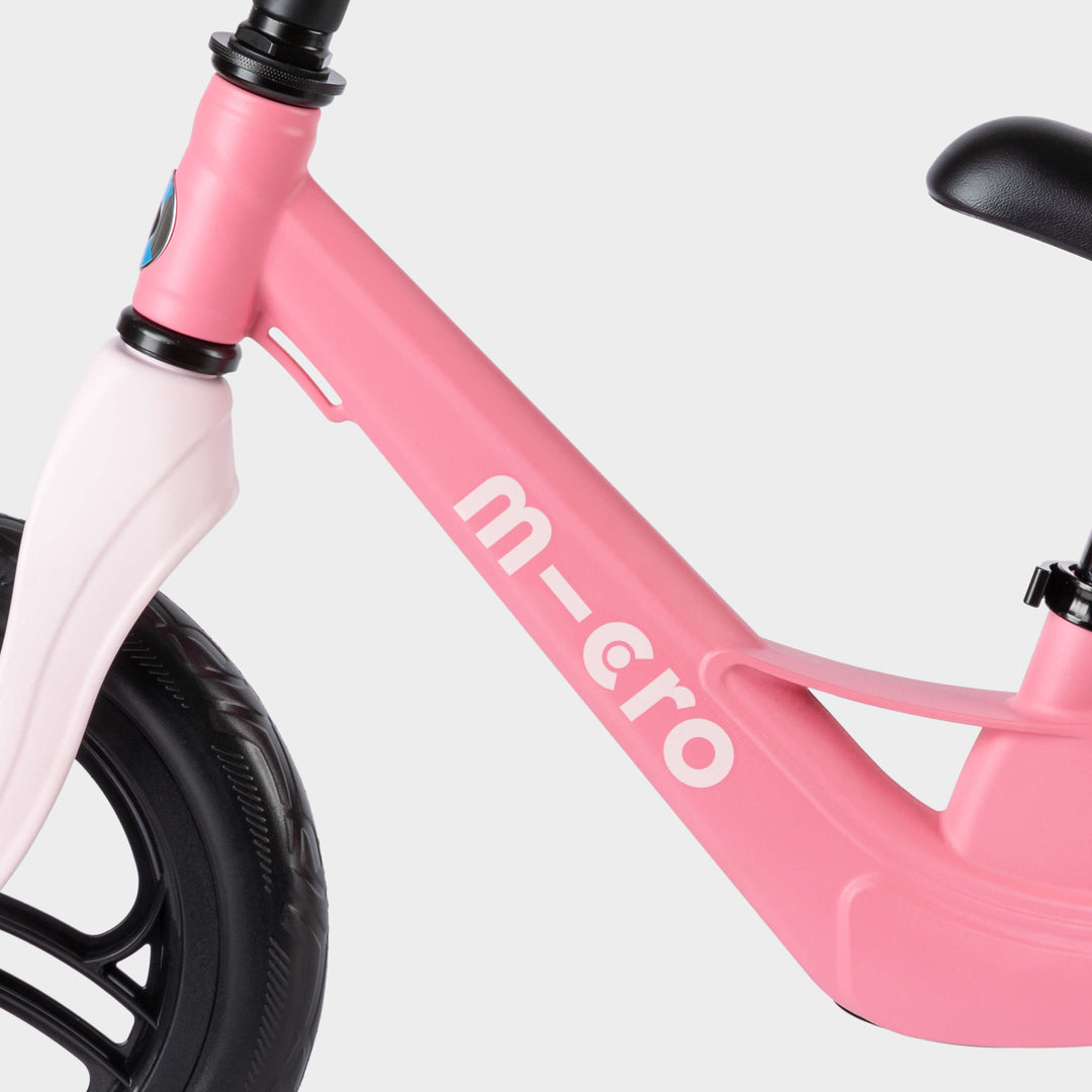 Close-up of the pink Micro Balance Bike Lite frame with the white micro logo