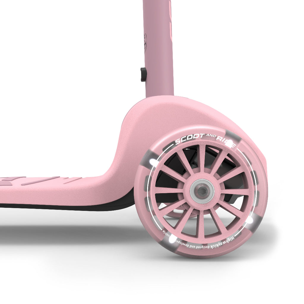 Close-up of a pink scooter wheel with 'Scoot and Ride' branding on a white background