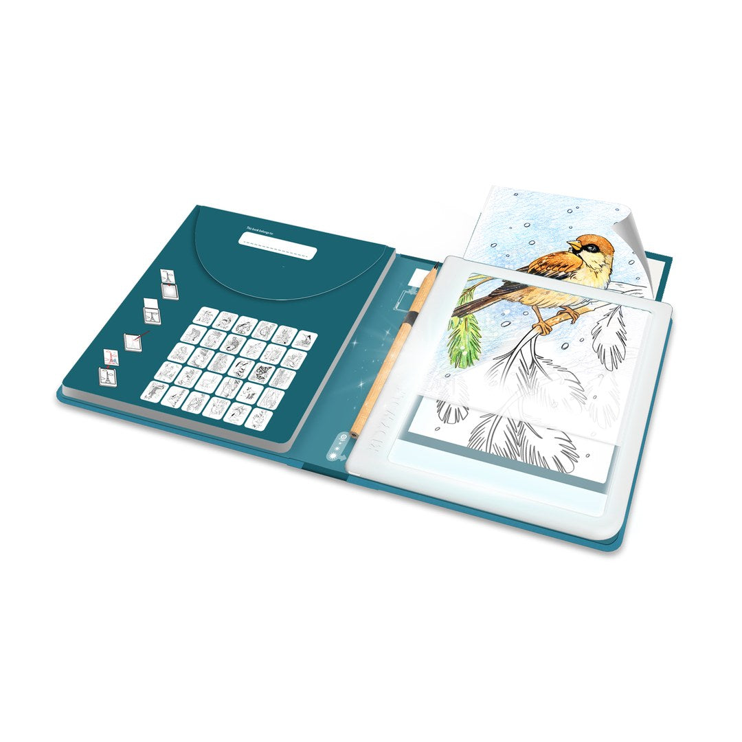 KIDYDRAW Pad Animals opened out, with the light pad lit up under a bird tracing card, a coloured-in bird drawing, a pencil and a design index on the inside cover
