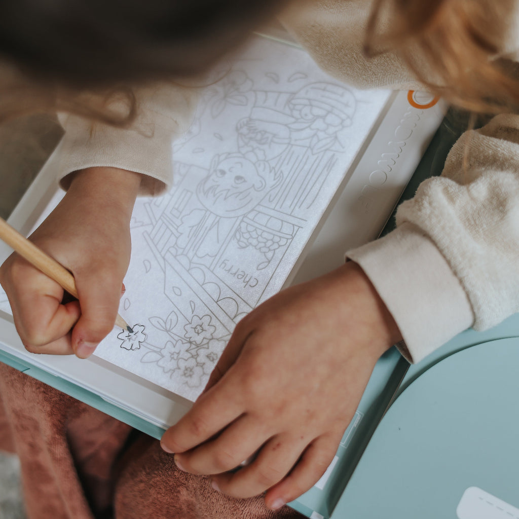 Person coloring in a book with a pencil