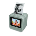 Kidywolf KIDYPRINTER AI mini printer in sage green printing a black and white picture, with a cartoon girl reading on its colour screen
