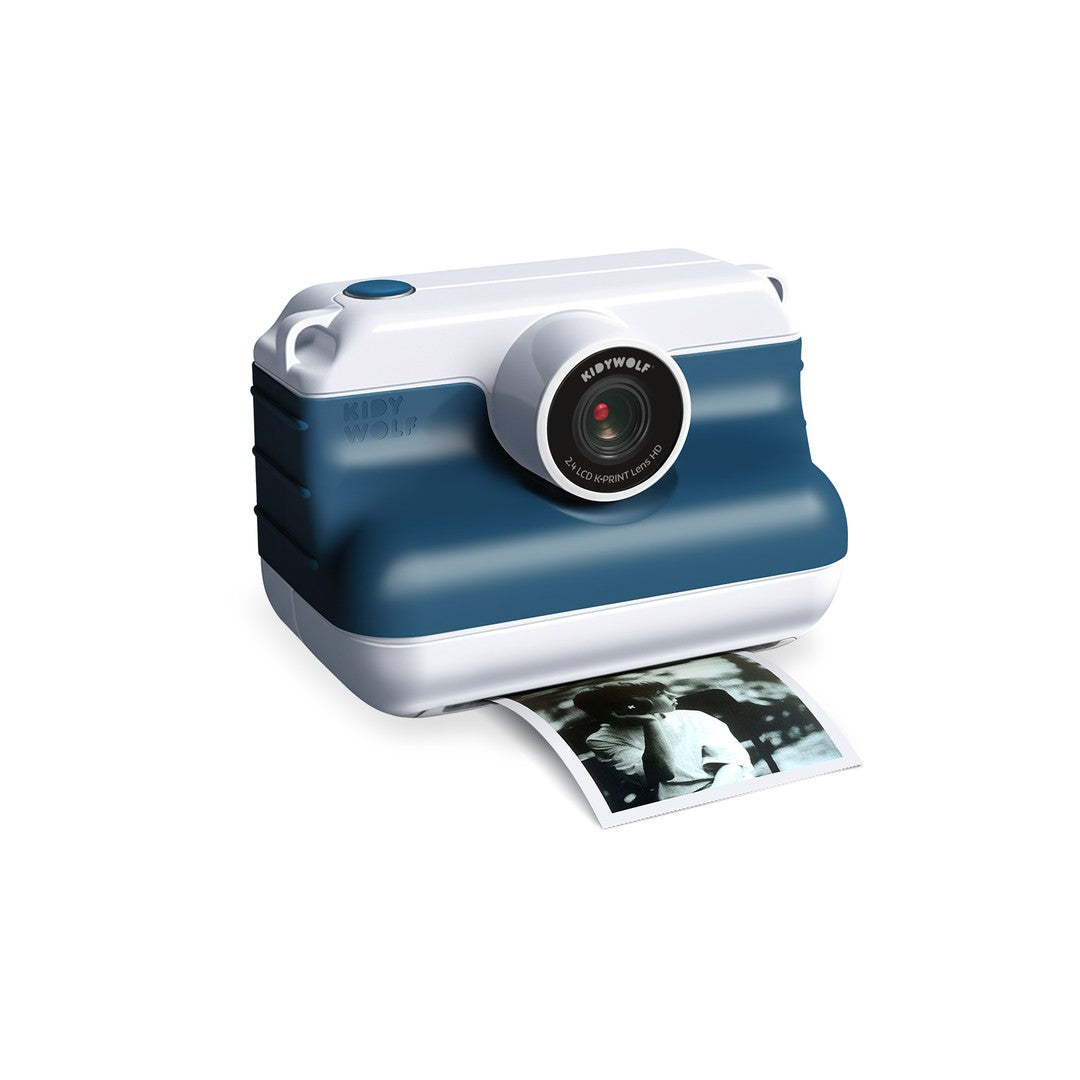 Kidywolf K-PRINT instant print camera in blue and white, printing a black and white photo from the front