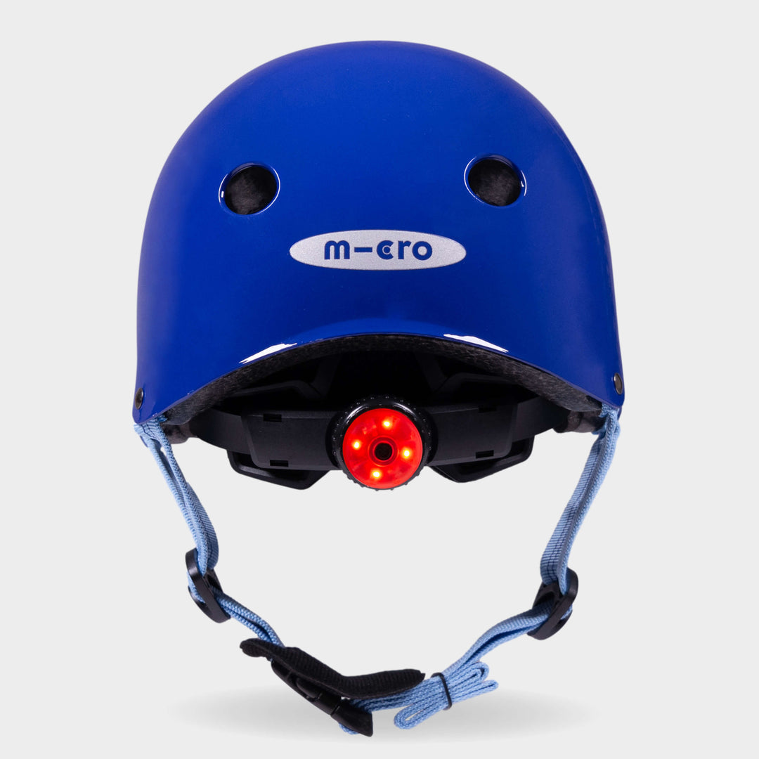 Back of the blue Micro plain helmet with the red rear safety light switched on