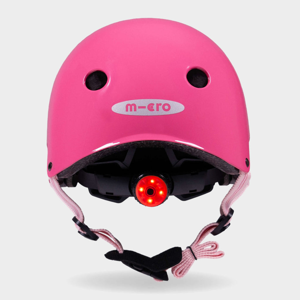Back of the pink Micro plain helmet with the red rear safety light switched on