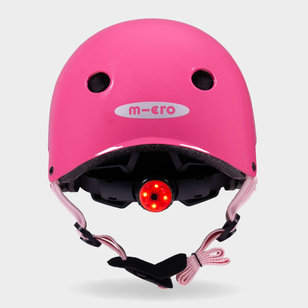 Back of the pink Micro plain helmet with the red rear safety light switched on