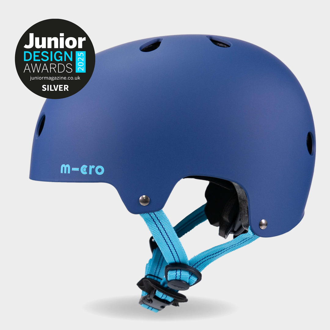 Navy Micro plain helmet side view with the Junior Design Awards Silver badge