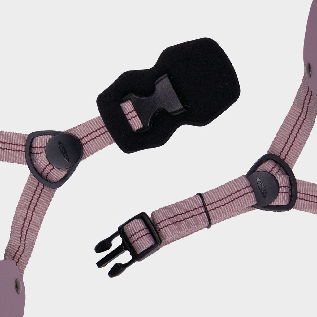 Close-up of the dusky pink adjustable straps and black buckle on the Micro plain helmet