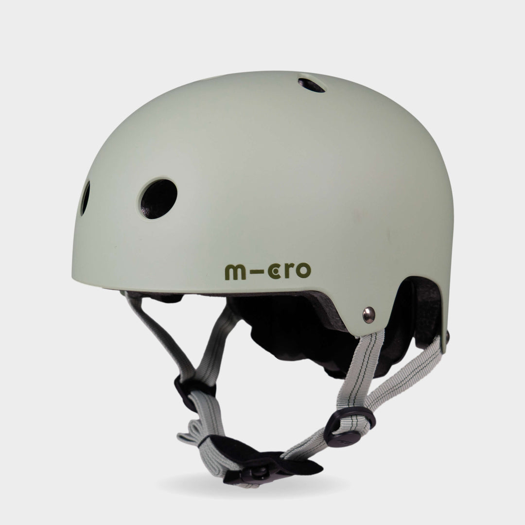 Micro plain helmet in matt sage green with grey-green straps, front three-quarter view