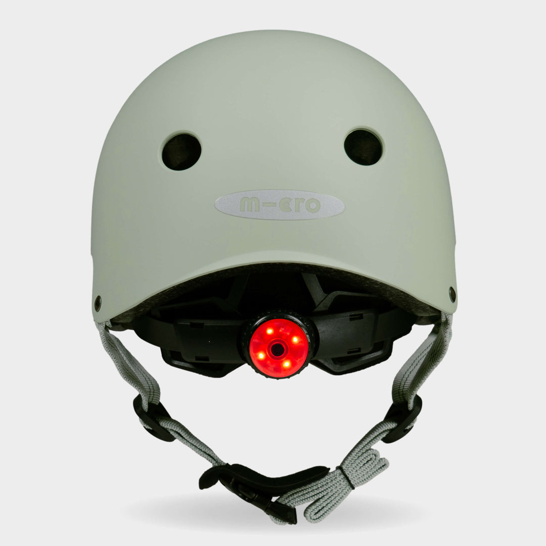 Back of the sage green Micro plain helmet with the red rear safety light switched on