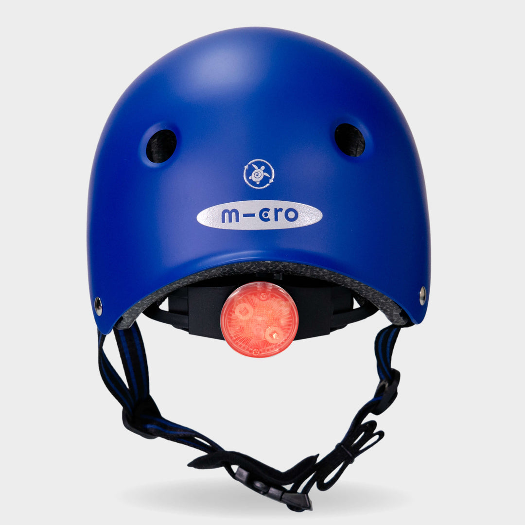 Back of the blue Micro Eco helmet with the red rear safety light switched on