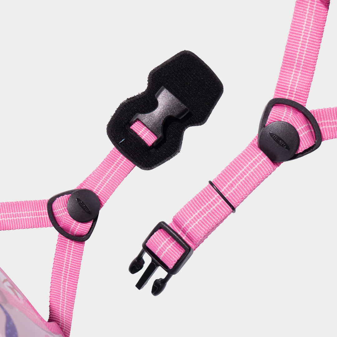 Close-up of the bright pink adjustable straps and black buckle on the Mermaid Micro helmet