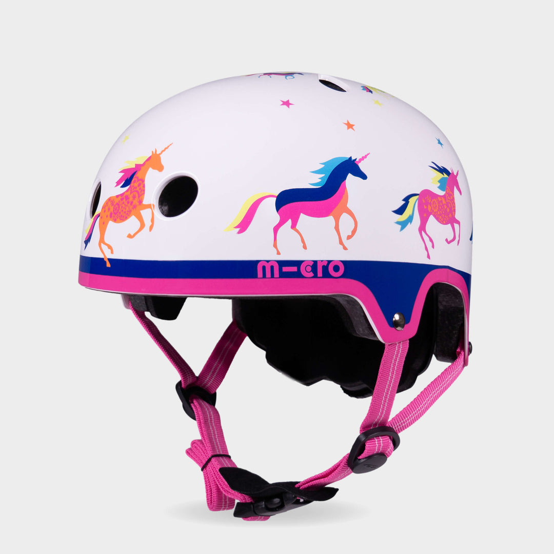 Micro printed helmet in white with a colourful unicorn and star pattern, navy band and pink straps, front three-quarter view