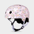 Micro printed helmet in pale pink with a flower and leaping hare pattern and lilac straps, front three-quarter view