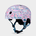 Micro printed helmet with a pink, lilac and teal dinosaur and flower pattern and teal straps, front three-quarter view