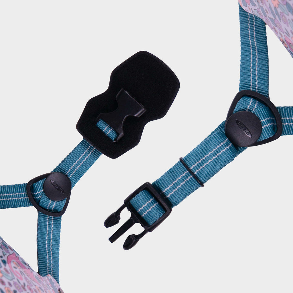 Close-up of the teal adjustable straps and black buckle on the Flora-Saur Micro helmet