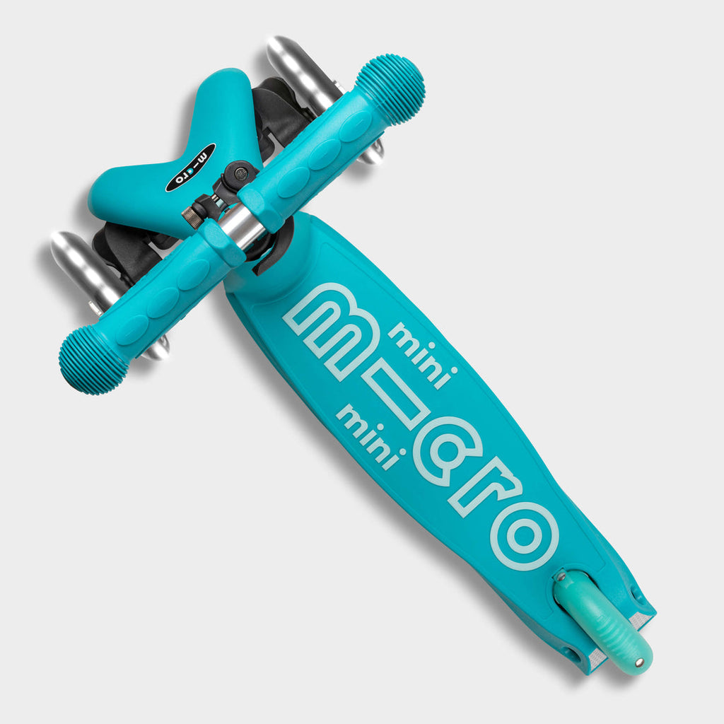 Top-down view of the aqua Mini Micro Deluxe deck with the mini micro logo and lean-to-steer front