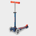 Mini Micro Deluxe LED three-wheel scooter in navy with red grips and light-up wheels, side view