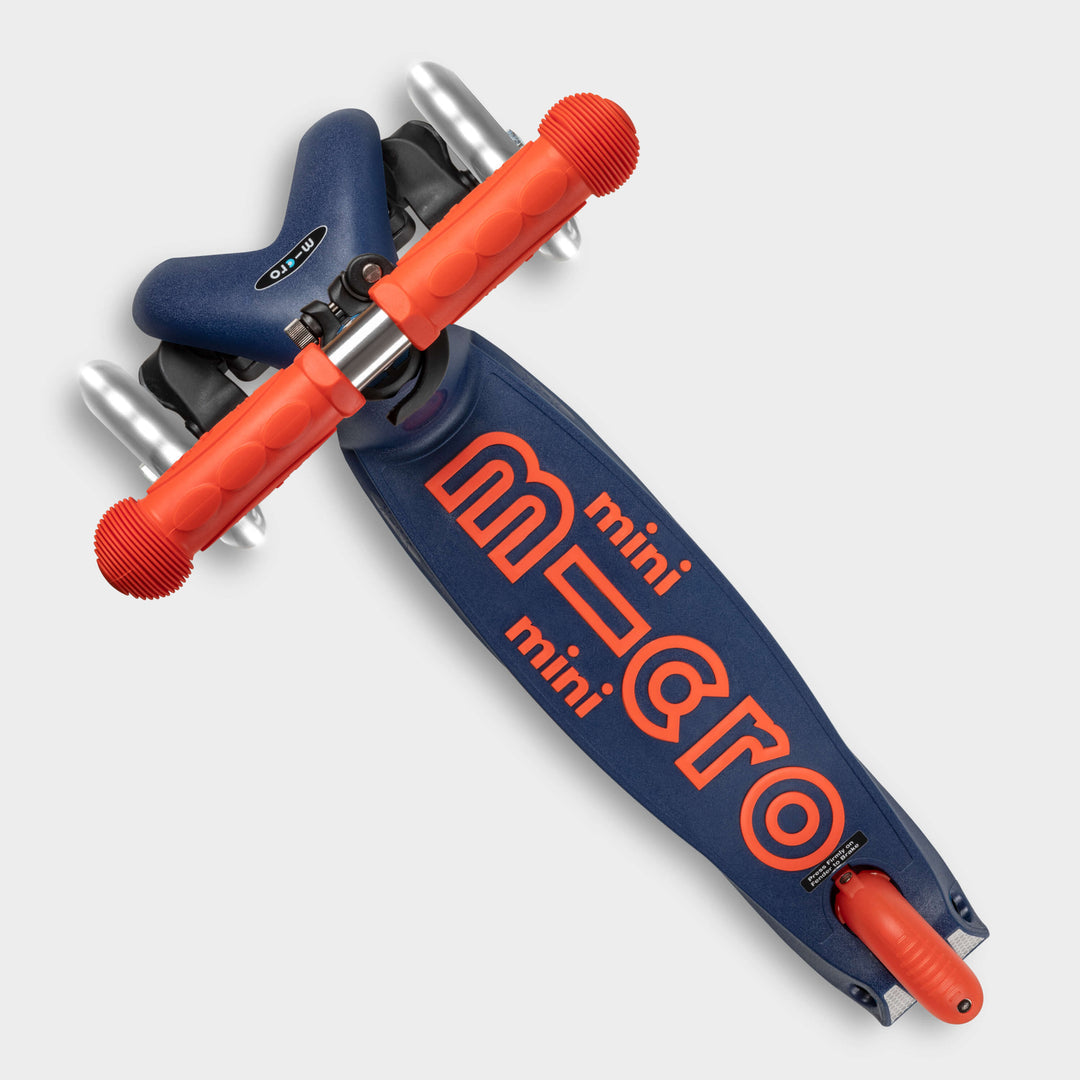 Top-down view of the navy Mini Micro Deluxe deck with the red mini micro logo and lean-to-steer front