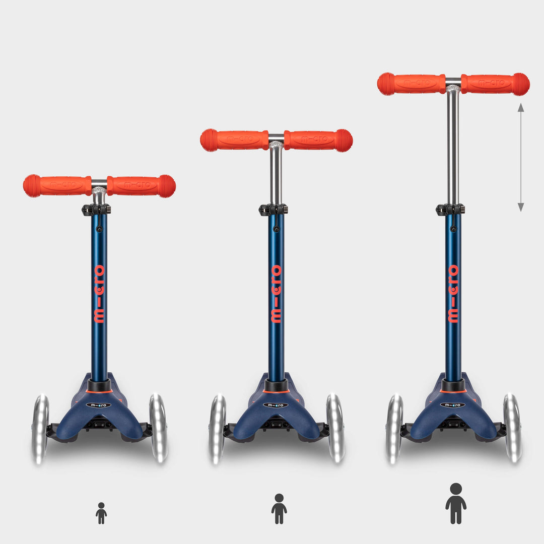 Three navy Mini Micro Deluxe LED scooters showing the handlebar height adjusting as a child grows