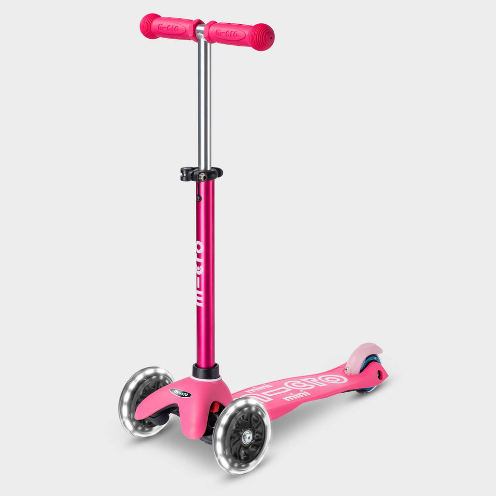 Mini Micro Deluxe LED three-wheel scooter in pink with light-up wheels, side view