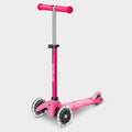 Mini Micro Deluxe LED three-wheel scooter in pink with light-up wheels, side view
