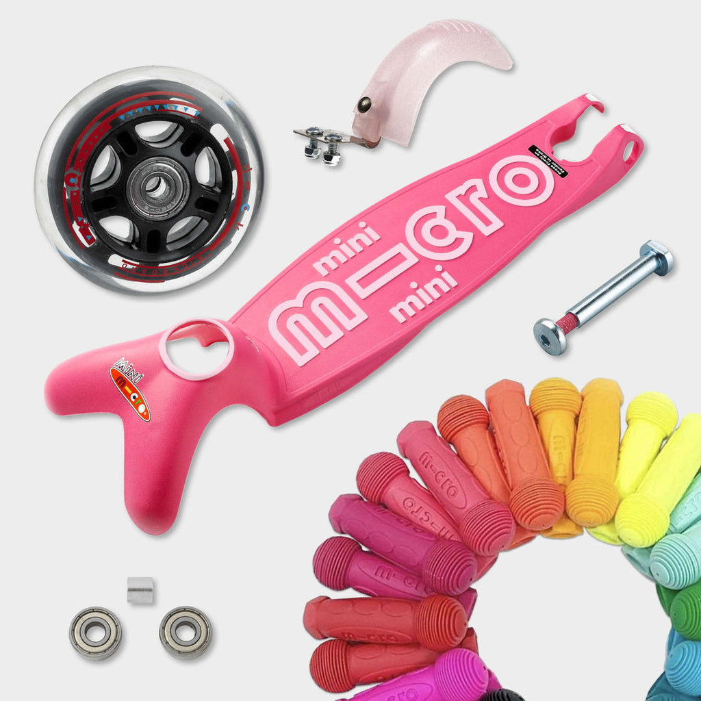 Replaceable parts for the pink Mini Micro Deluxe: spare wheel, deck, axle, bearings, brake and coloured grips