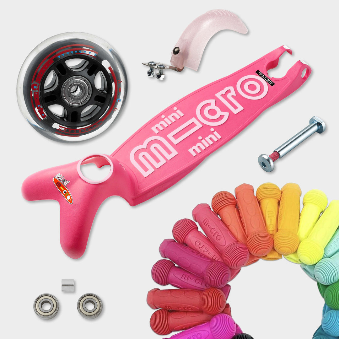 Replaceable parts for the pink Mini Micro Deluxe: spare wheel, deck, axle, bearings, brake and coloured grips