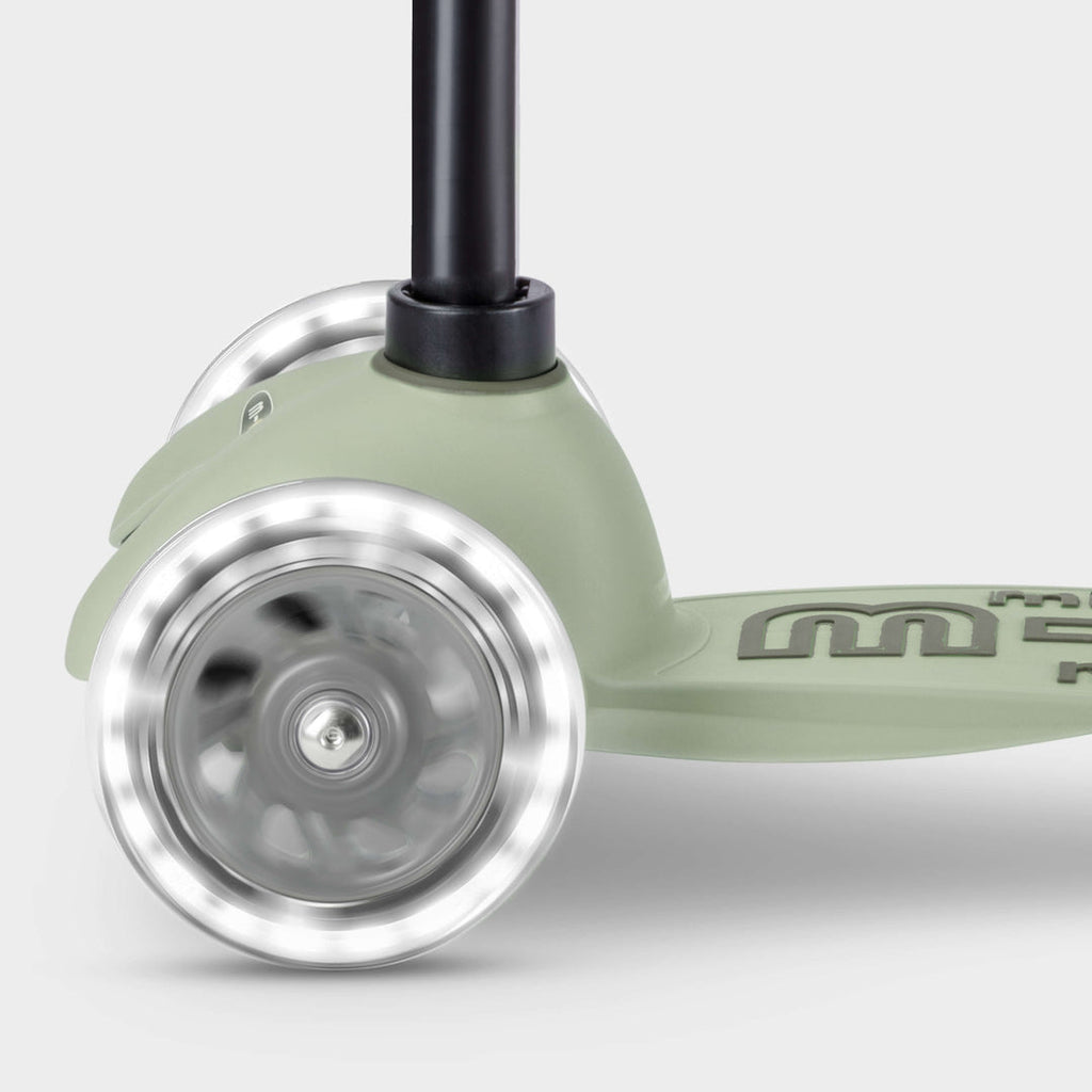 Close-up of the light-up LED front wheels on the sage green Micro Mini2Grow Deluxe