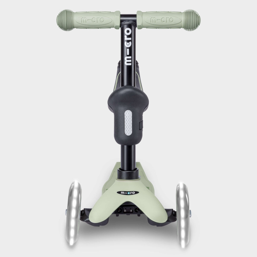 Front view of the sage green Micro Mini2Grow Deluxe scooter with light-up front wheels